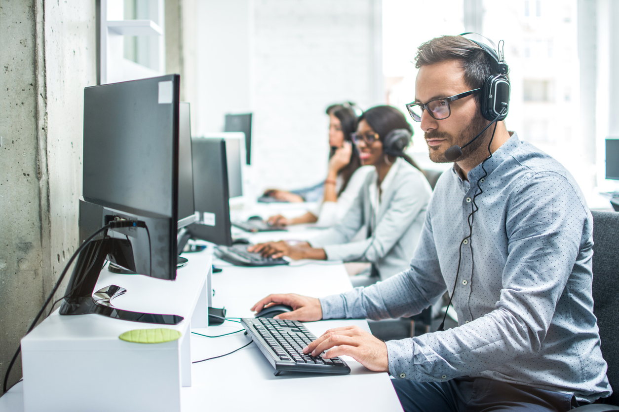 handsome young male customer support executive working in office.